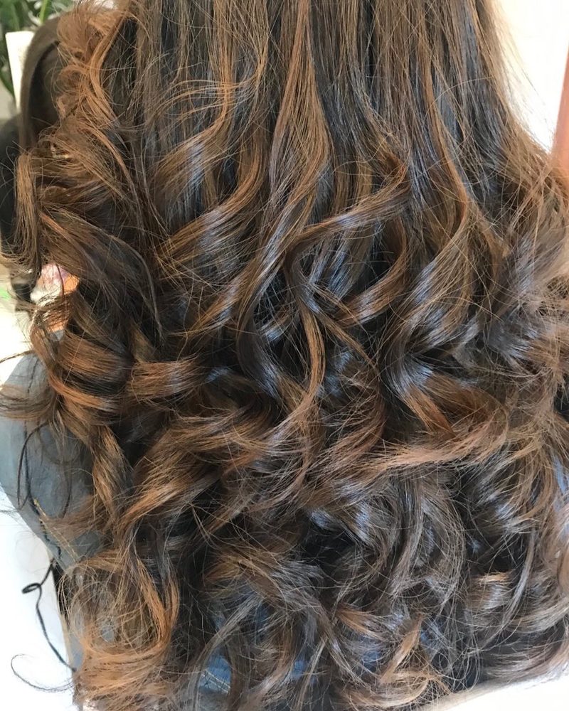 Dark brunette with caramel highlights and curls