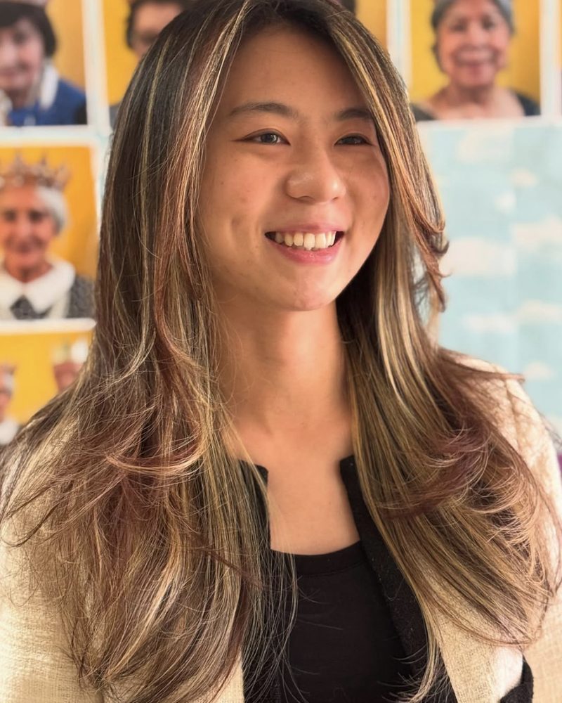 Client smiling with soft blonde highlights